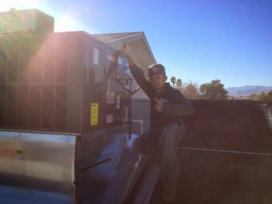 HVAC technician performing HVAC Inspection on a rooftop unit in Blairstown
